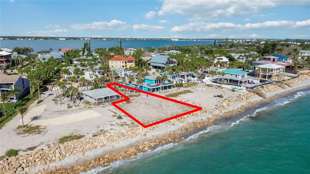 An aerial view shows a vacant beachfront lot outlined in red next to existing houses — 4076 N BEACH ROAD UNIT CTG6, ENGLEWOOD, FL