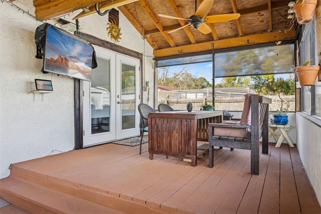 A living room features light wood flooring, a stone fireplace, and dark gray accent walls — 1023 N BASK DRIVE, TAMPA, FL