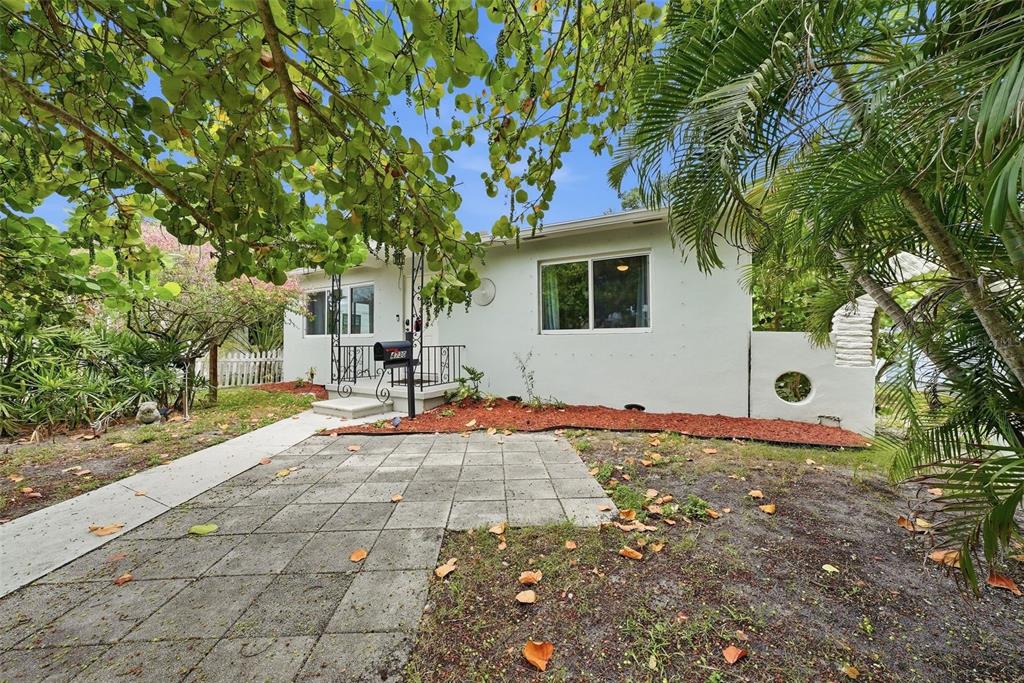 A white, single-story house with a paved front patio and a small porch — 4730 BURLINGTON AVENUE N, ST PETERSBURG, FL