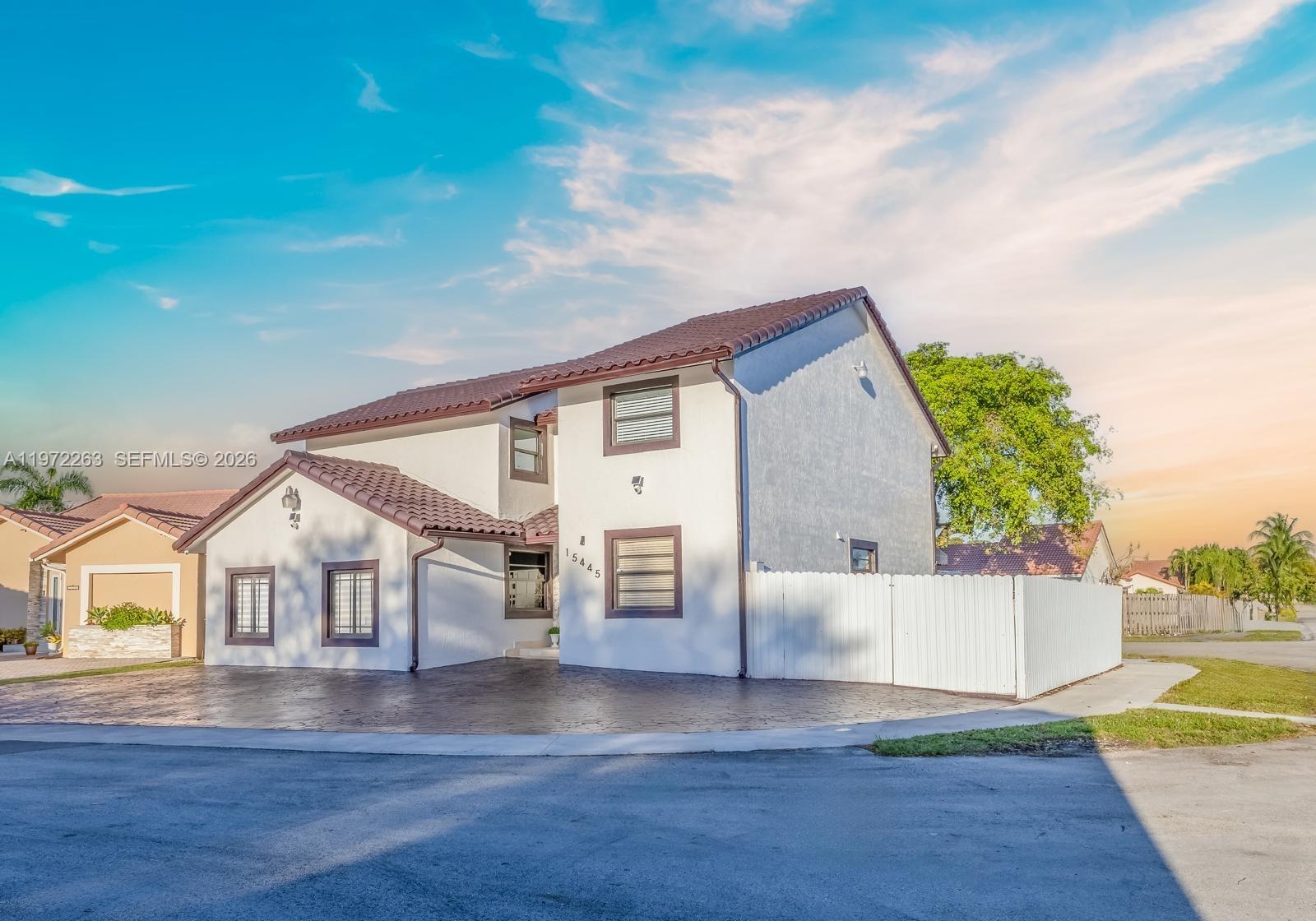 A two-story white house with a brown tile roof and a paved driveway — 15445 SW 57th St, Miami FL 33193, MIAMI, FL