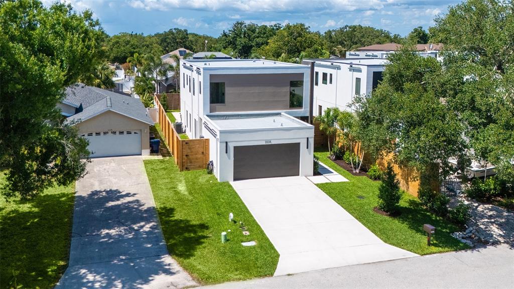 An aerial view shows a modern two-story house with a flat roof and attached garage — 2225 FLORINDA STREET, SARASOTA, FL