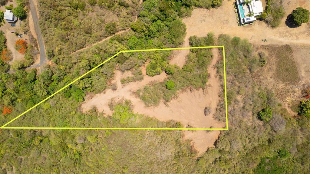 An aerial view shows a vacant, irregularly shaped plot of land outlined in yellow — 55 CALLE DE BATU, VIEQUES, PR