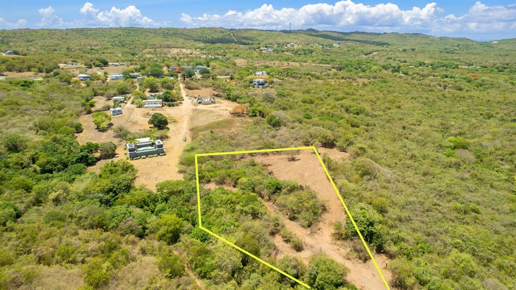 An aerial view shows a vacant, partially cleared plot of land surrounded by tropical vegetation — 55 CALLE DE BATU, VIEQUES, PR
