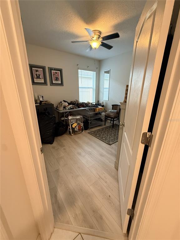 A small room with light wood-look flooring, a ceiling fan, and a window — 329 WINGED ELM DRIVE, DEBARY, FL
