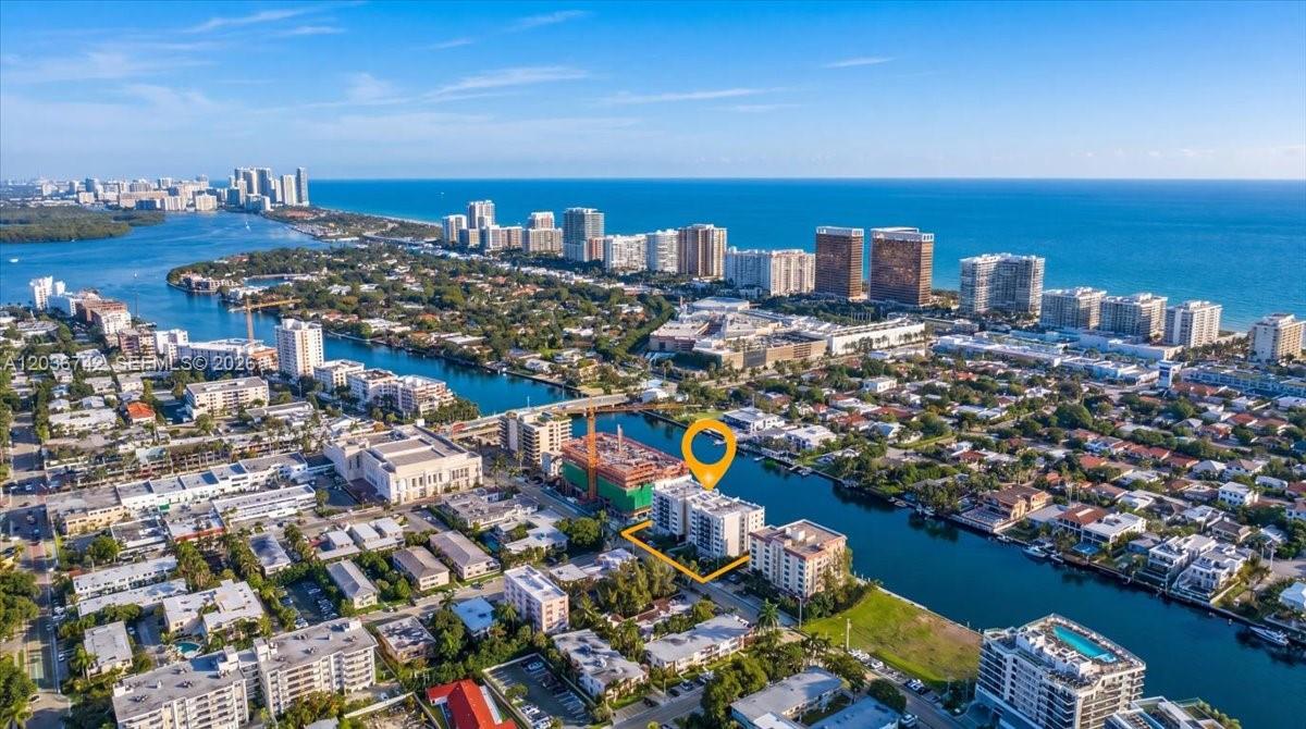An aerial view shows a waterfront residential area with buildings and a construction site — 9381 E Bay Harbor Dr # 404S, Bay Harbor Islands FL 33154, BAY HARBOR ISLANDS, FL