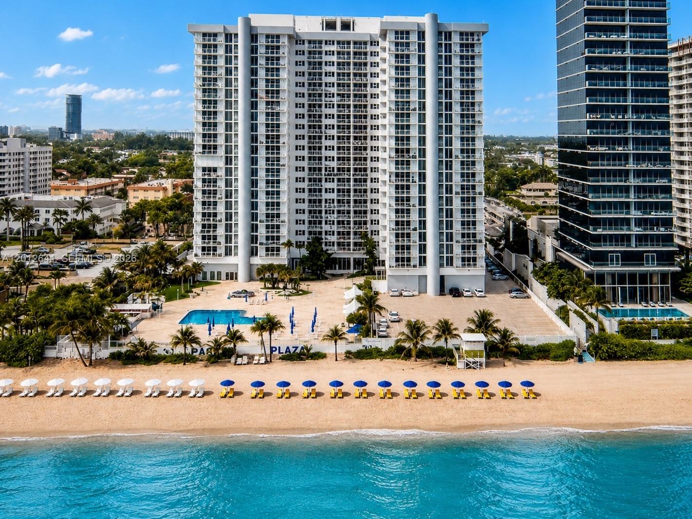 An aerial view shows a tall residential building with a pool deck facing the beach — 2030 S Ocean Dr # 309, Hallandale Beach FL 33009, HALLANDALE BEACH, FL