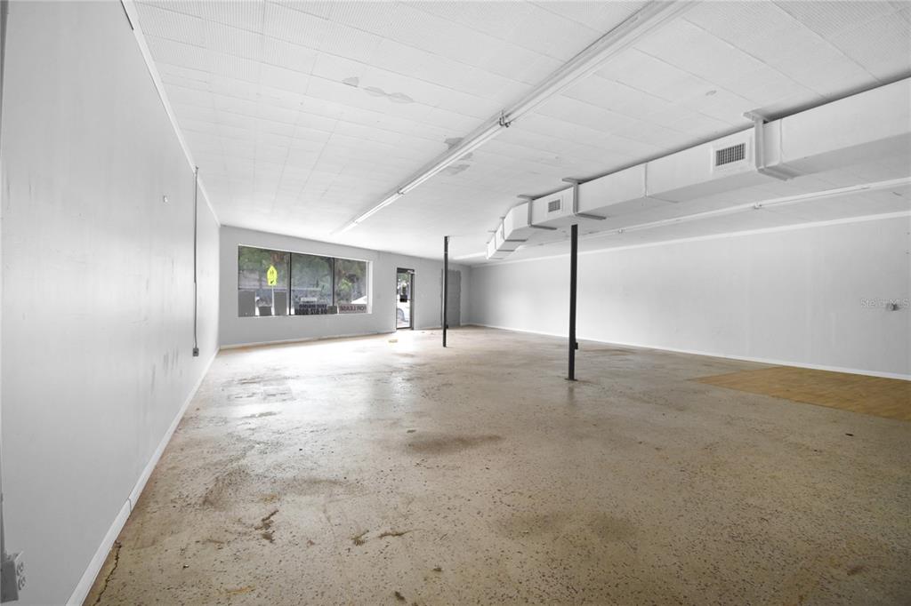 An empty commercial space features white walls, a drop ceiling, and a concrete floor — 5818 SAINT AUGUSTINE ROAD, JACKSONVILLE, FL