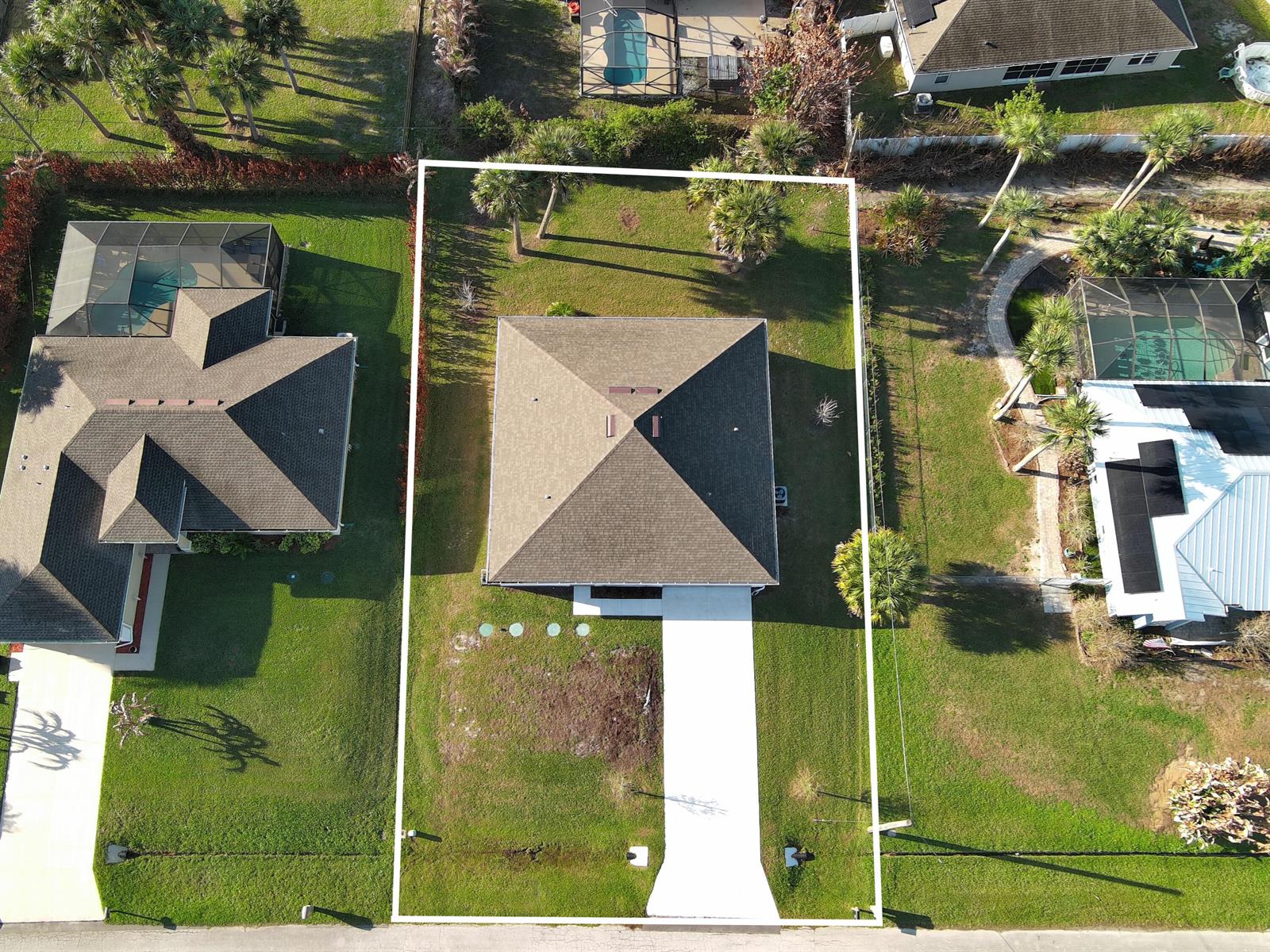 An aerial view shows a single-story house with a hip roof and a concrete driveway — 450 Kendall Avenue, Sebastian FL 32958, SEBASTIAN, FL