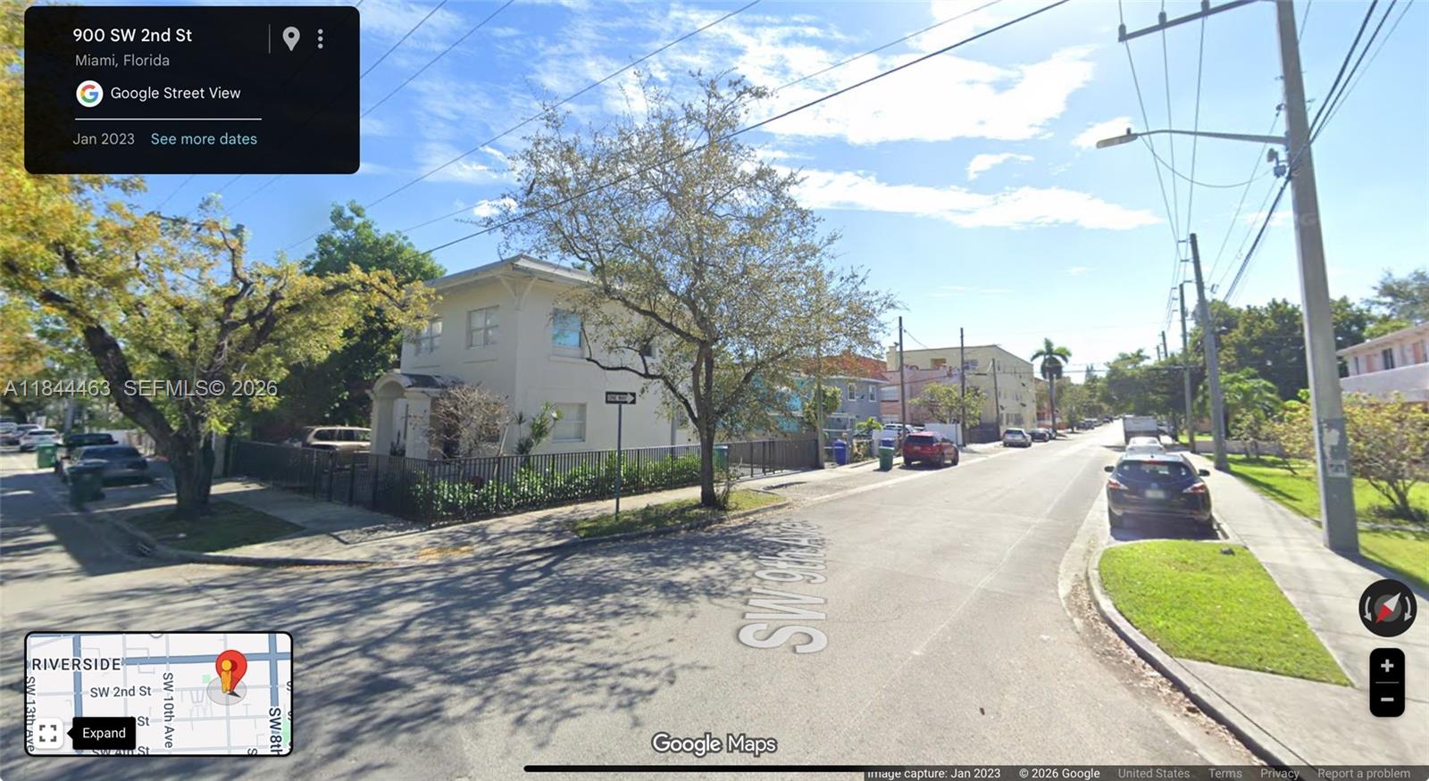 A two-story beige house sits on a corner lot with a black metal fence — 876 SW 2nd St, Miami FL 33130, MIAMI, FL