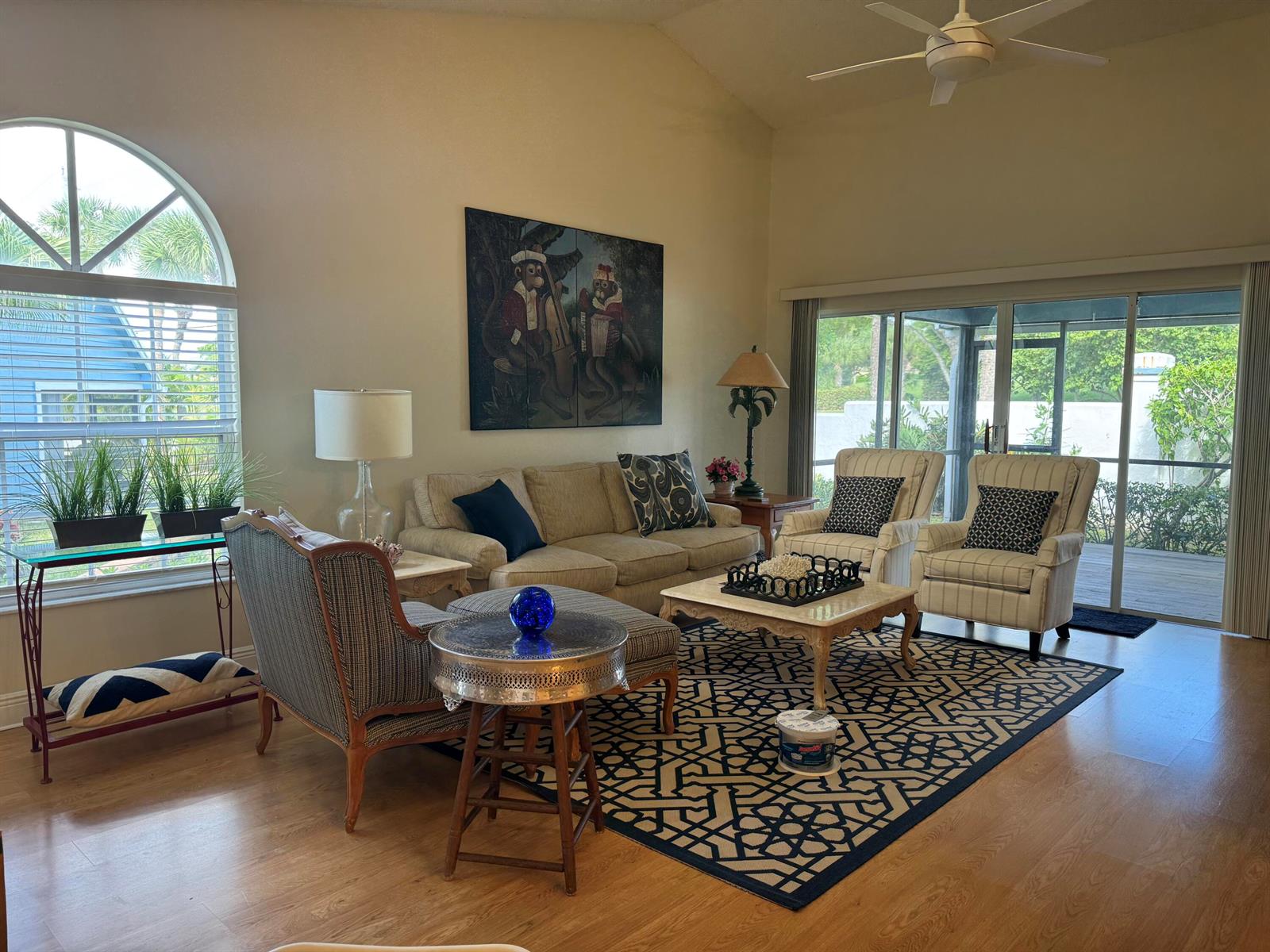 A living room features a patterned area rug, a sofa, two armchairs, and large windows — 108 Ocean Dunes Circle # 108, Jupiter FL 33477, JUPITER, FL