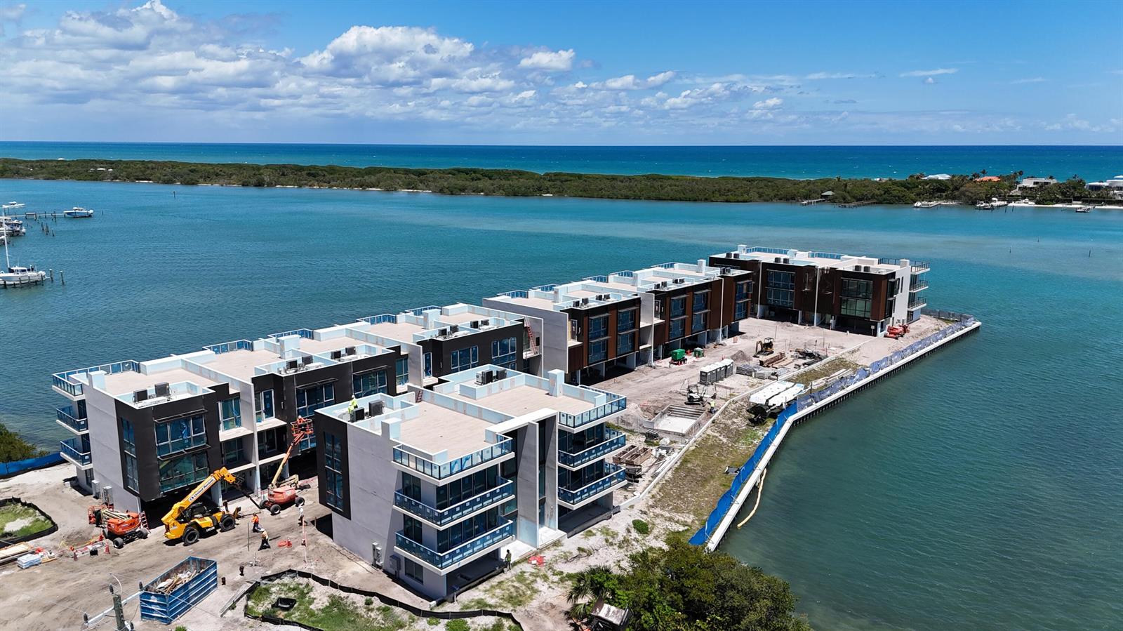 An aerial view shows a multi-story residential building under construction along a waterfront — 12450 SE Crystal Cove Place # 6, Jupiter FL 33469, JUPITER, FL