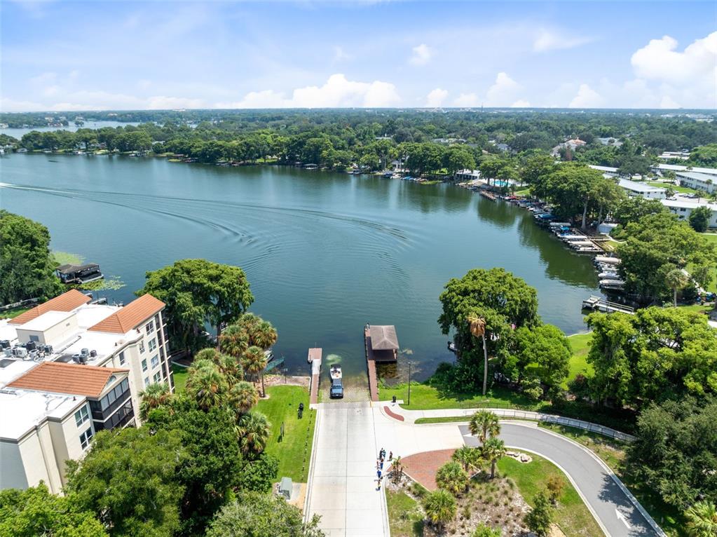 An aerial view shows a boat ramp leading into a lake near a residential building — 1140 S ORLANDO AVENUE UNIT B-7, MAITLAND, FL
