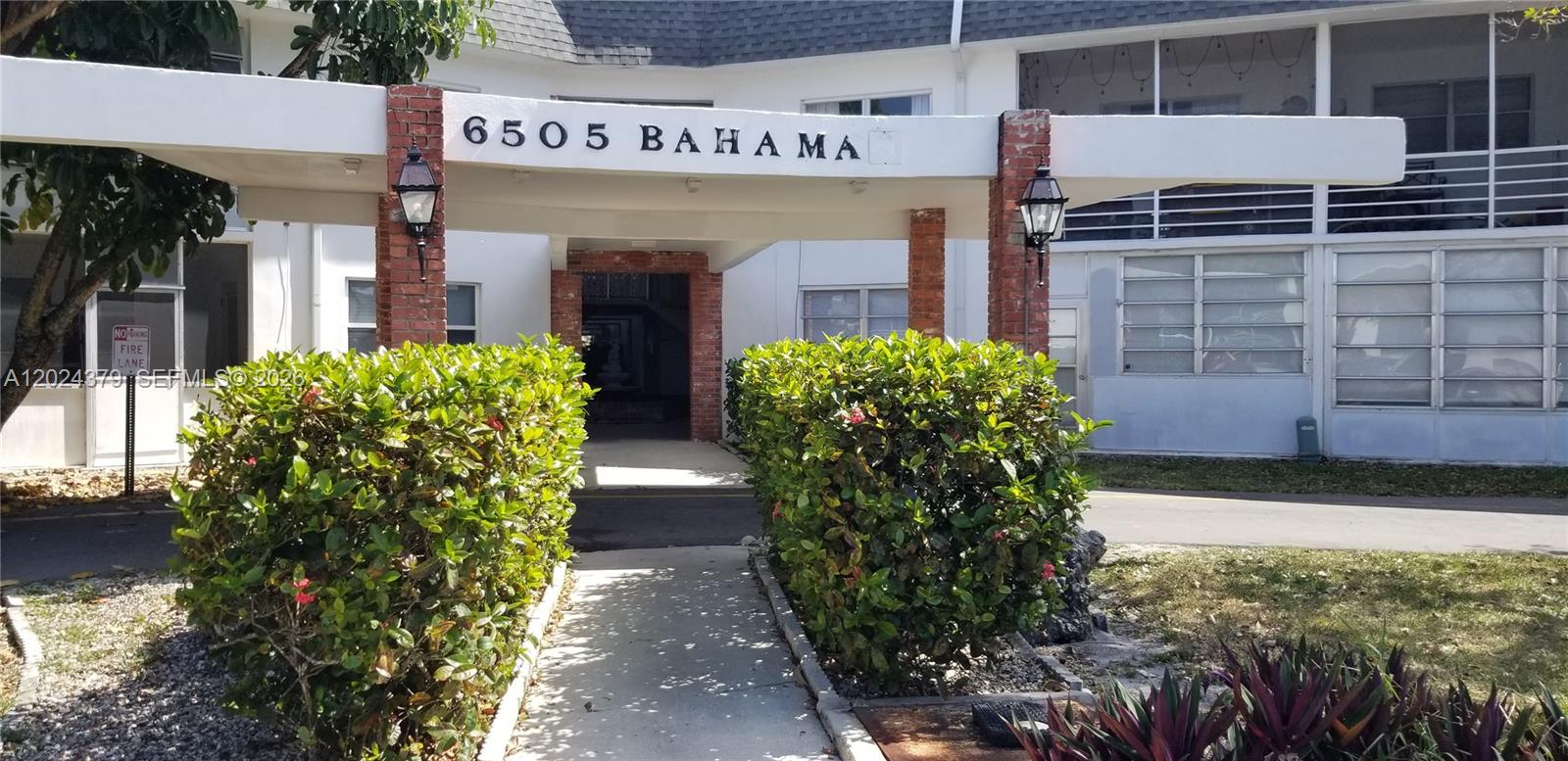 A covered walkway leads to the entrance of a building with brick pillars — 6505 Winfield Blvd # 3, Margate FL 33063, MARGATE, FL