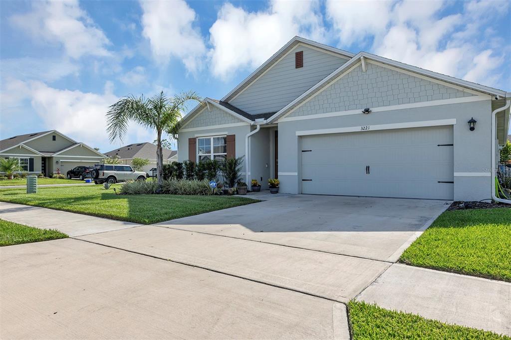 A light gray single-story house with a two-car garage and a front lawn — 3221 SILAS DRIVE, NEW SMYRNA BEACH, FL
