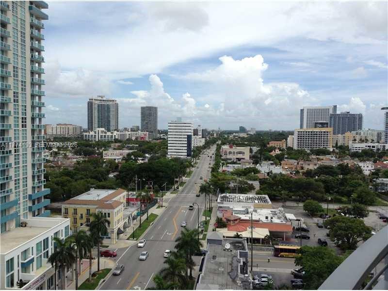 An elevated view of a city street lined with buildings, trees, and parked cars — 350 NE 24th St # 1108, Miami FL 33137, MIAMI, FL