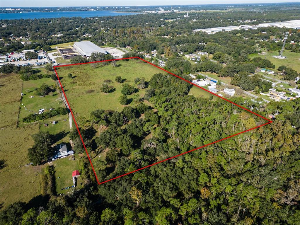 An aerial view shows a large, rectangular plot of land outlined in red — 1525 FISH HATCHERY ROAD, LAKELAND, FL