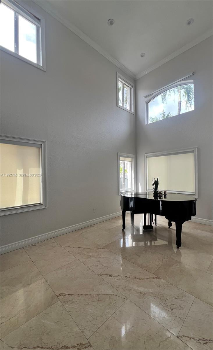 A high-ceilinged room features light-colored tile flooring, multiple windows, and a black grand piano — 5513 SW 164th Ct, Miami FL 33185, MIAMI, FL