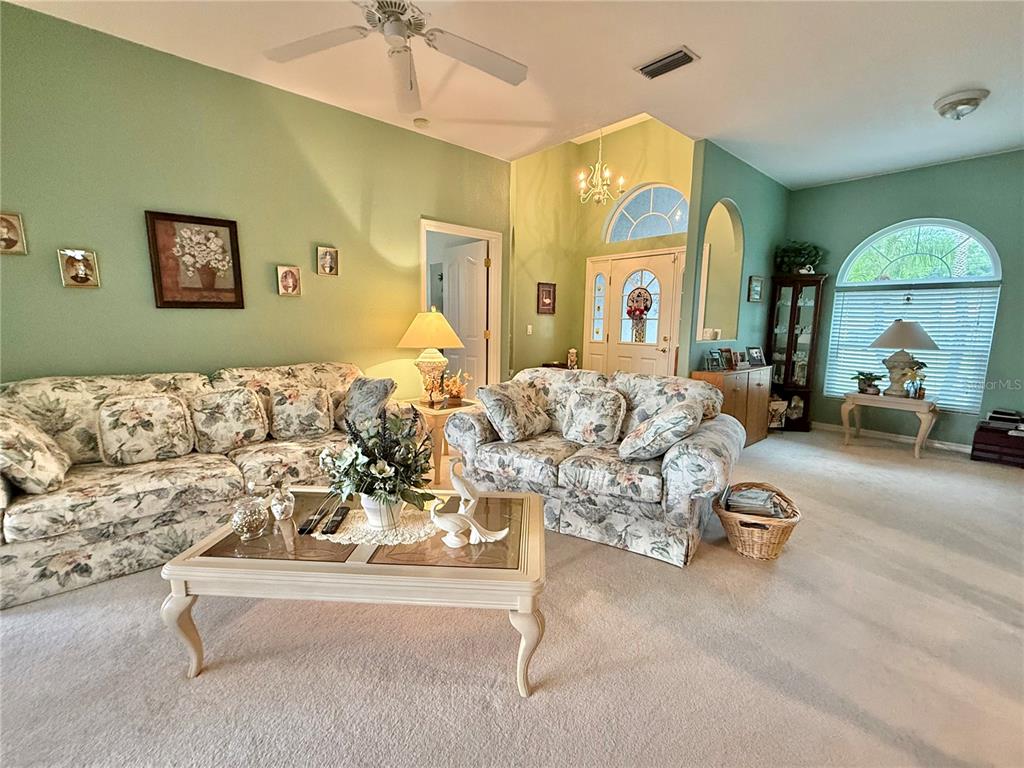 A living room features floral sofas, a glass-top coffee table, and light green walls — 4015 CLEARFIELD STREET, NORTH PORT, FL