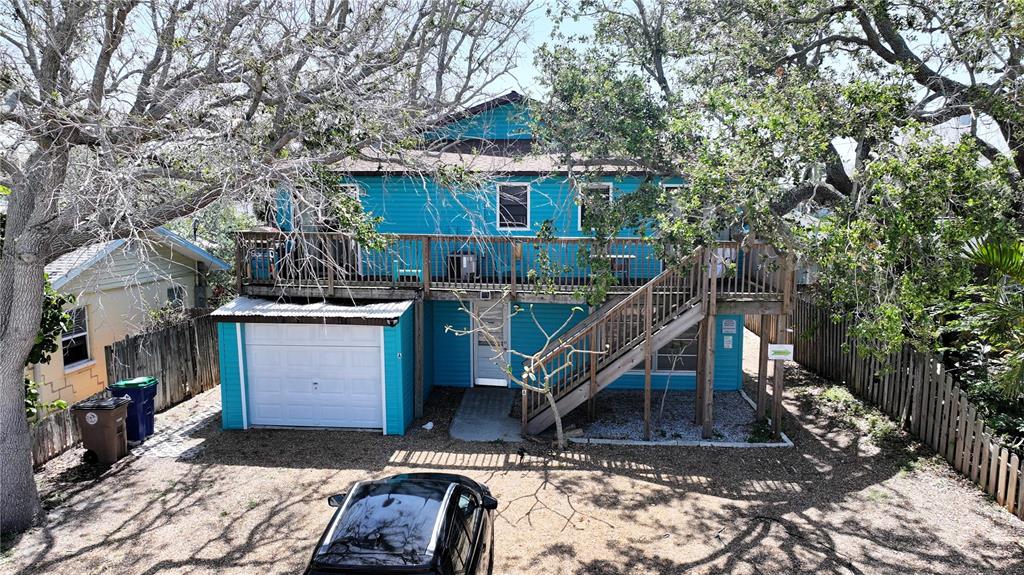 A two-story blue house with a garage, an elevated deck, and an outdoor staircase — 725 1ST STREET, INDIAN ROCKS BEACH, FL