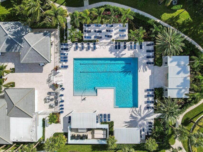 An aerial view of a rectangular swimming pool surrounded by lounge chairs and palm trees — 1206 Mainsail Circle, Jupiter FL 33477, JUPITER, FL