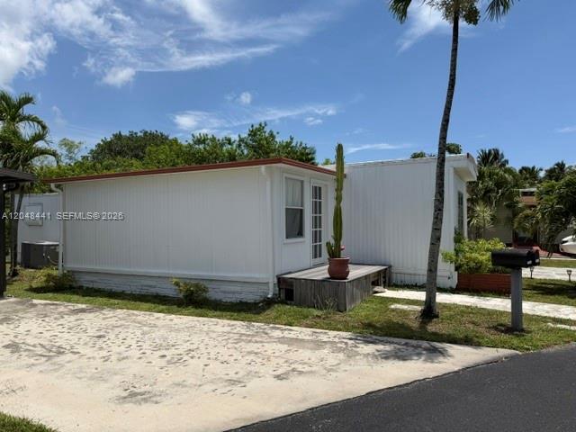 A white mobile home with a small wooden deck and a tall cactus in a pot — 5331 SW 35th ST, Davie FL 33314, DAVIE, FL