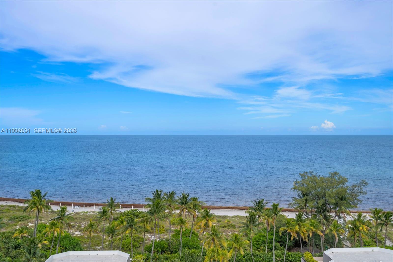 A view of a sandy beach and ocean from an elevated perspective — 251 Crandon Blvd # 1037, Key Biscayne FL 33149, KEY BISCAYNE, FL