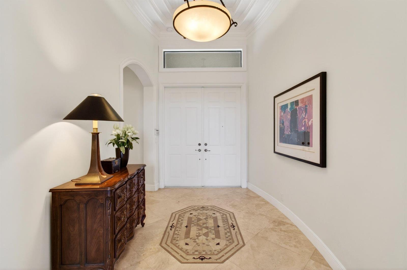 A foyer features a tile floor with an inlay, a wooden chest, and double doors — 16266 Rosecroft Terrace, Delray Beach FL 33446, DELRAY BEACH, FL