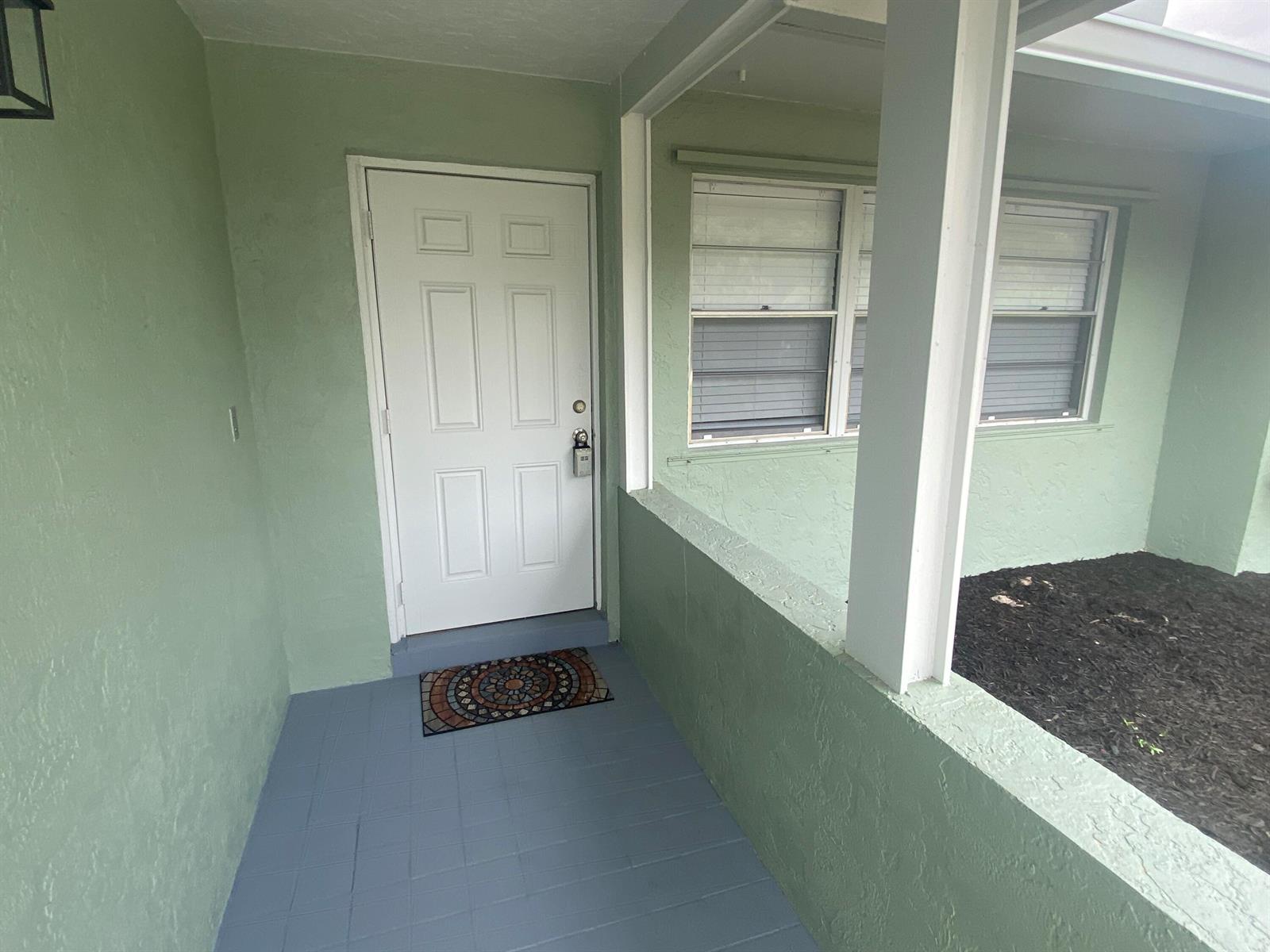 A single-story house with a concrete driveway, a garage, and a mailbox in the foreground — 1317 Willow Road, West Palm Beach FL 33406, WEST PALM BEACH, FL