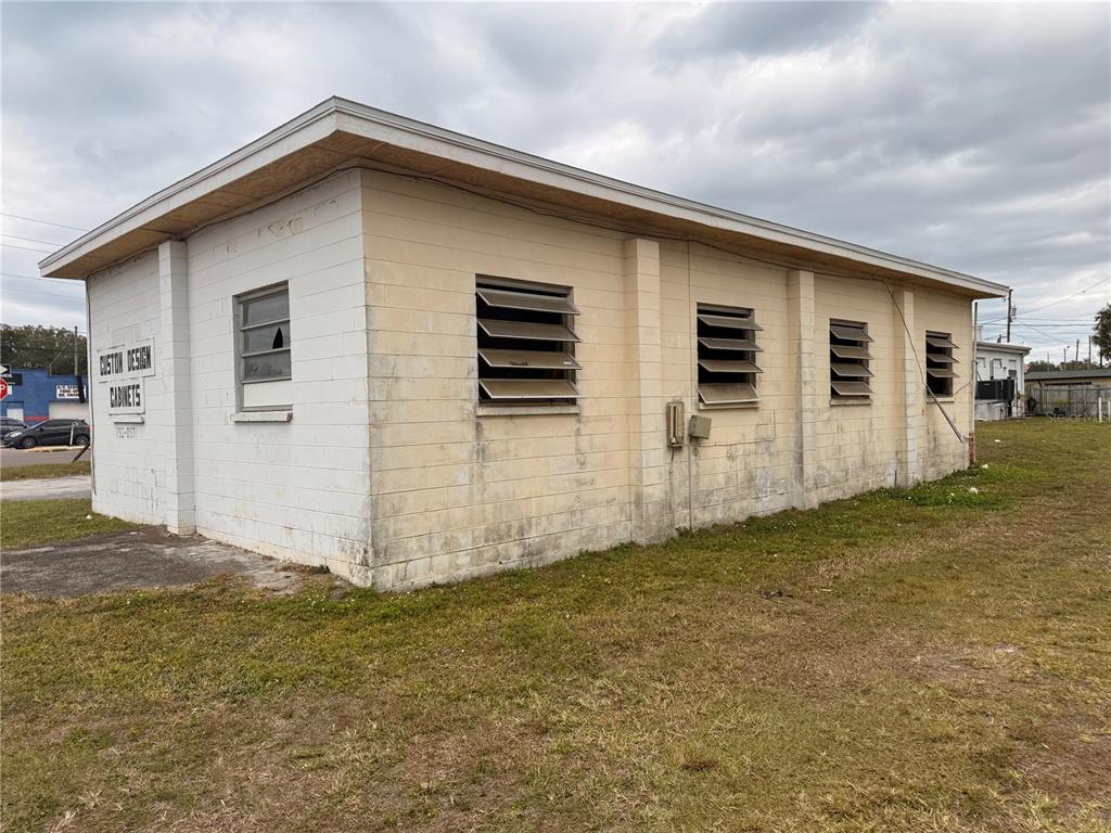 A single-story concrete block commercial building with louvered windows and a flat roof — 1305 E BAKER STREET, PLANT CITY, FL