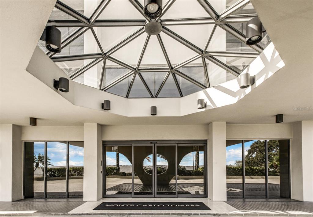 The entrance to Monte Carlo Towers features a glass skylight and sliding glass doors — 3301 BAYSHORE BOULEVARD UNIT 505C, TAMPA, FL