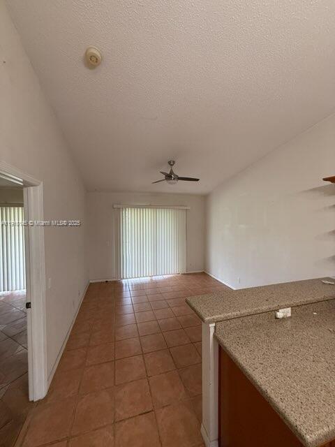 An interior view shows a living room with tile floors, a ceiling fan, and sliding doors — 3171 Holiday Springs Blvd # 5, Margate FL 33063, MARGATE, FL