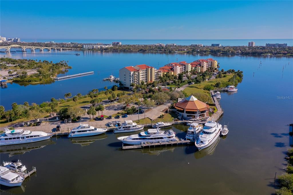 An aerial view shows a waterfront condominium complex with a marina and docked yachts — 732 MARINA POINT DRIVE UNIT 7320, DAYTONA BEACH, FL