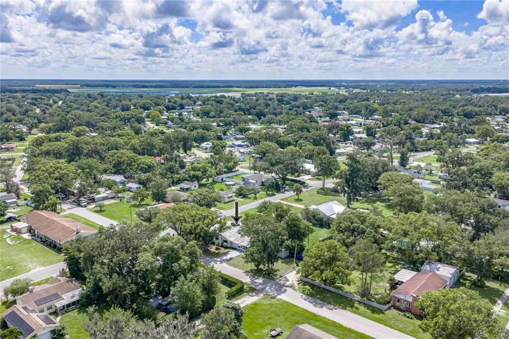 An aerial view shows a residential neighborhood with a single-story house marked by an arrow — 5207 10TH STREET, ZEPHYRHILLS, FL