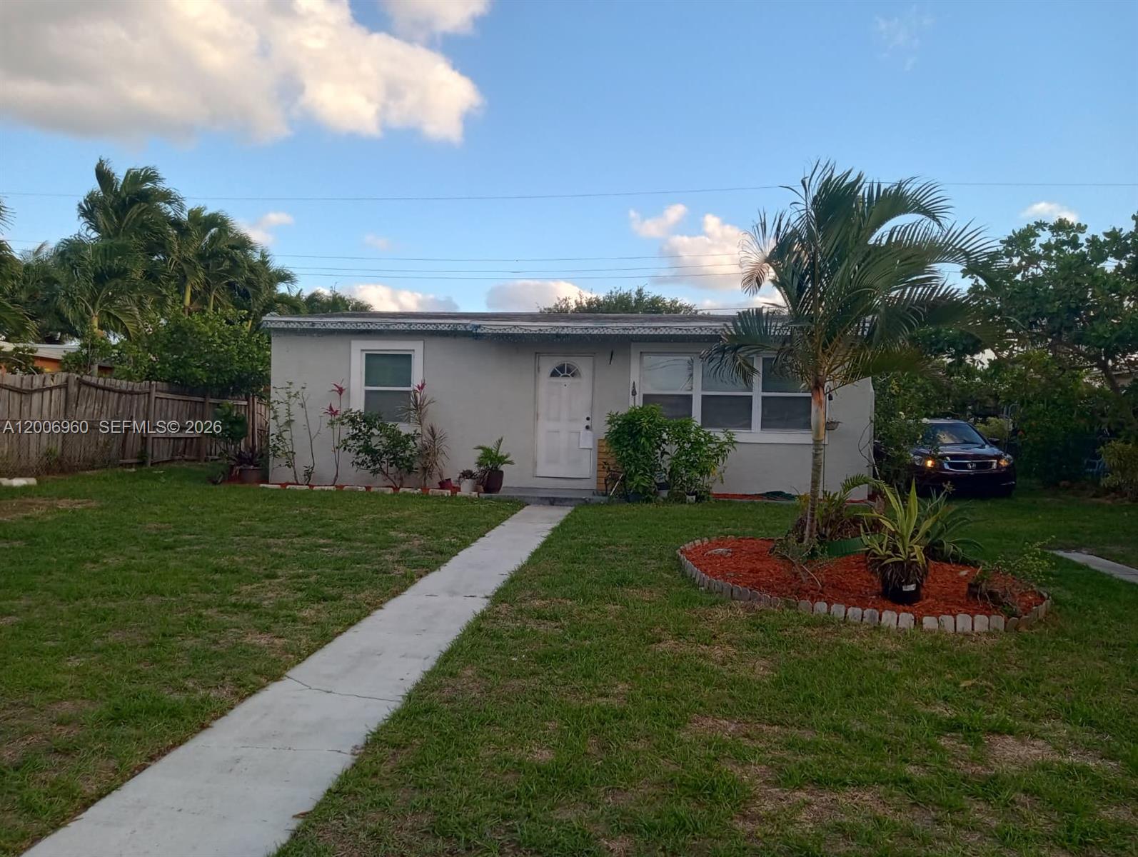 A single-story house with a white door, a concrete walkway, and a palm tree — 508 Beech Rd, West Palm Beach FL 33409, WEST PALM BEACH, FL