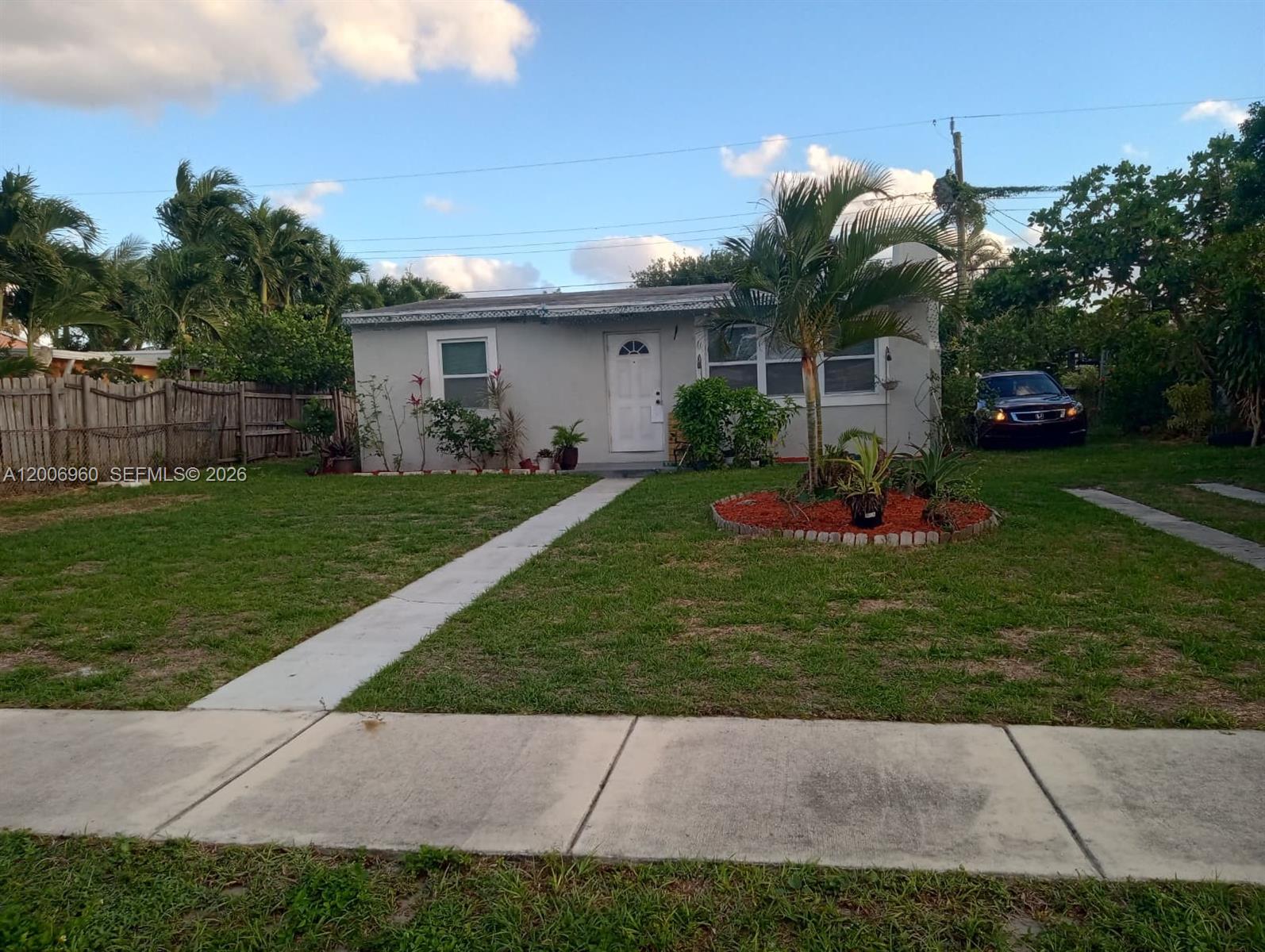 A single-story house with a white door, a concrete walkway, and a landscaped front yard — 508 Beech Rd, West Palm Beach FL 33409, WEST PALM BEACH, FL