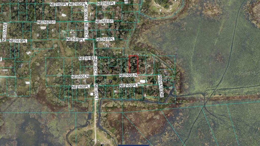 This is an aerial map showing a highlighted parcel of land surrounded by wetlands — TBD NE 106 LANE, CITRA, FL