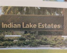 A sign with the text Indian Lake Estates stands in front of trees and landscaping — 0 TROPICANA DRIVE, INDIAN LAKE ESTATES, FL