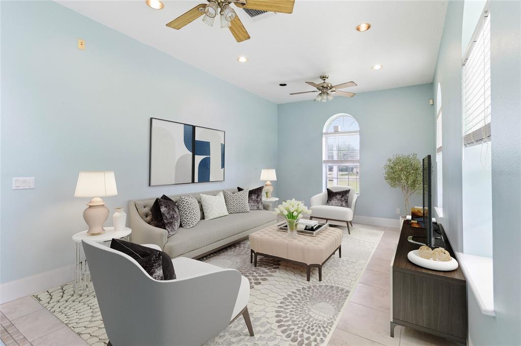 A living room features light blue walls, a grey sofa, two armchairs, and a patterned rug — 31243 BEAR POND DRIVE, SORRENTO, FL