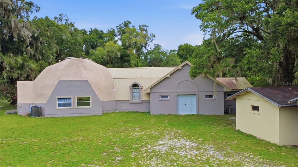 An exterior view of a dome-shaped house with a connected rectangular section and a shed — 1320 W TAYLOR ROAD, DELAND, FL