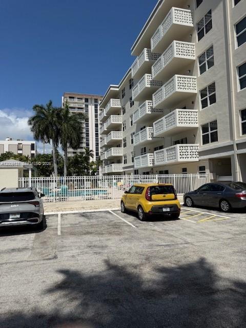 A parking lot sits in front of a multi-story apartment building with white balconies — 1901 S Ocean Dr # 207, Hollywood FL 33019, HOLLYWOOD, FL