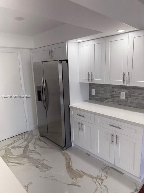 A kitchen features white shaker cabinets, stainless steel appliances, and white marble-patterned tile flooring — 1901 S Ocean Dr # 207, Hollywood FL 33019, HOLLYWOOD, FL