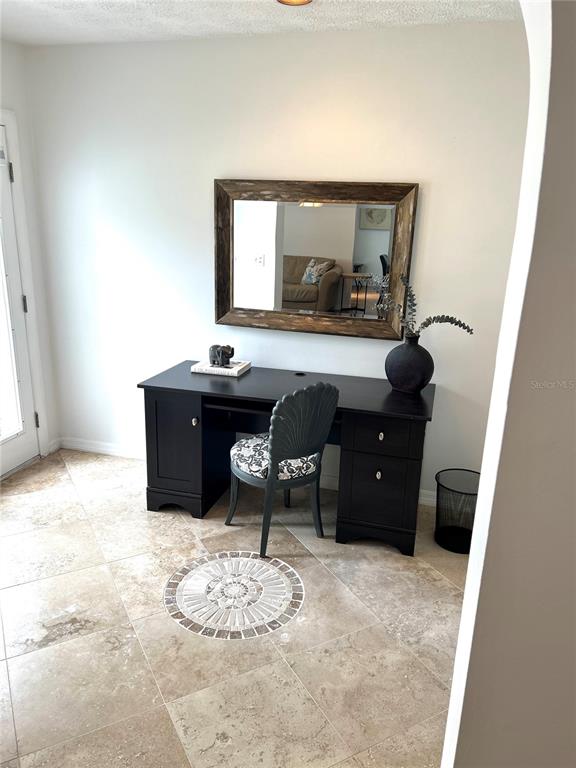 A home office features a wooden desk, a computer monitor, built-in shelving, and a mirror — 3014 W MASON STREET UNIT A, TAMPA, FL