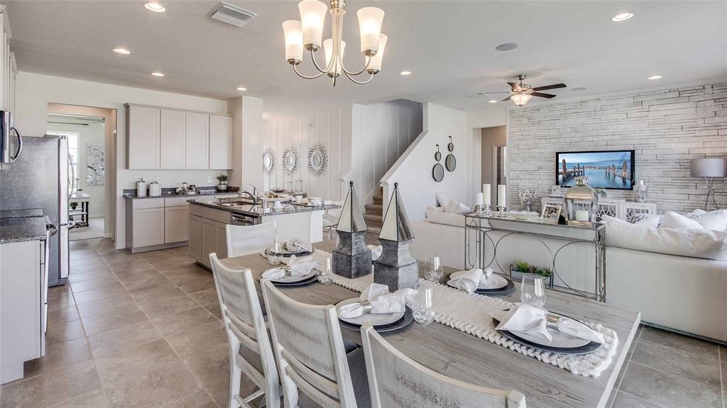An empty room features light-colored walls, wood-look flooring, and two windows overlooking a neighborhood — 5432 SILVER MOONLIGHT DRIVE, PALMETTO, FL