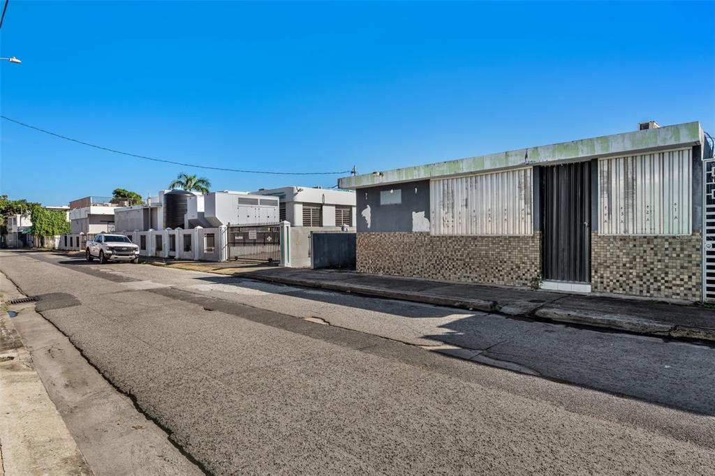 A street-level view shows a low-rise building with tiled siding and metal shutters — #2 CALLE PADRE RIVERA WEST, HUMACAO, PR