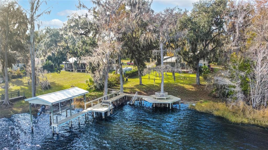 An aerial view of a wooden dock with a boat slip extending into a lake — 6121 S SUNWAY POINT, FLORAL CITY, FL