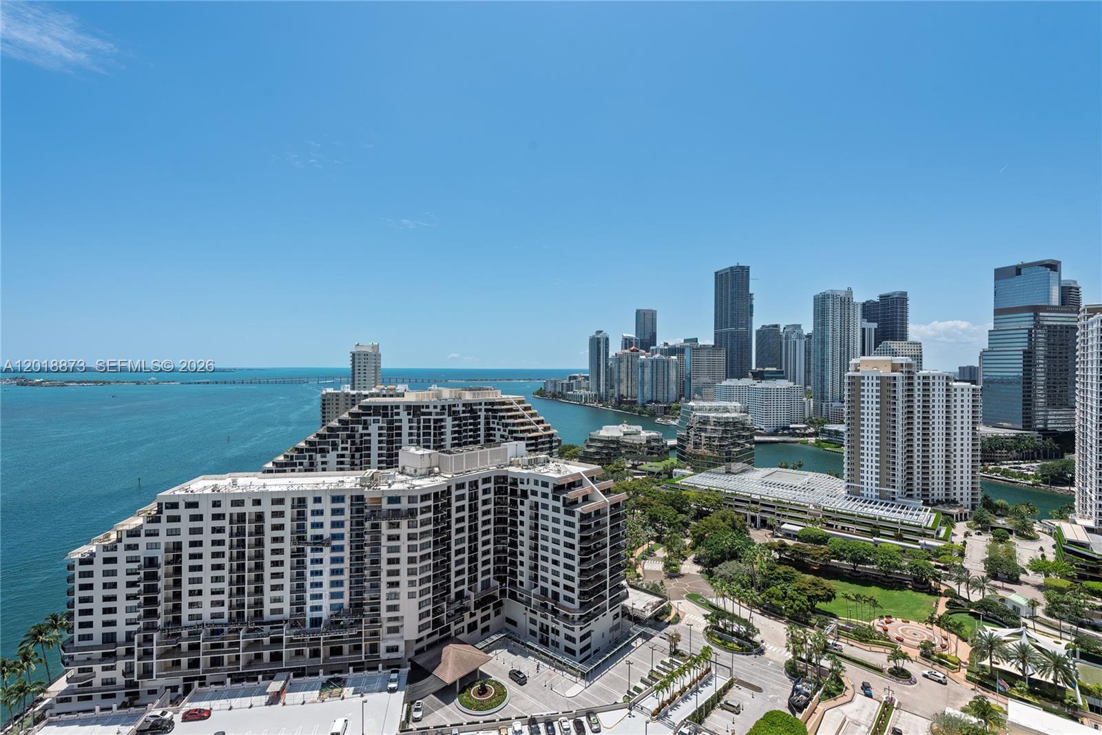 An elevated view shows a large apartment complex overlooking a bay and city skyline — 848 Brickell Key Dr # 2703, Miami FL 33131, MIAMI, FL