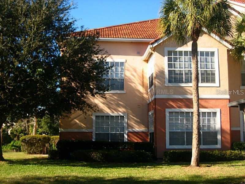 A two-story stucco building with a tile roof and a palm tree in the front — 4126 CENTRAL SARASOTA PARKWAY UNIT 2011, SARASOTA, FL