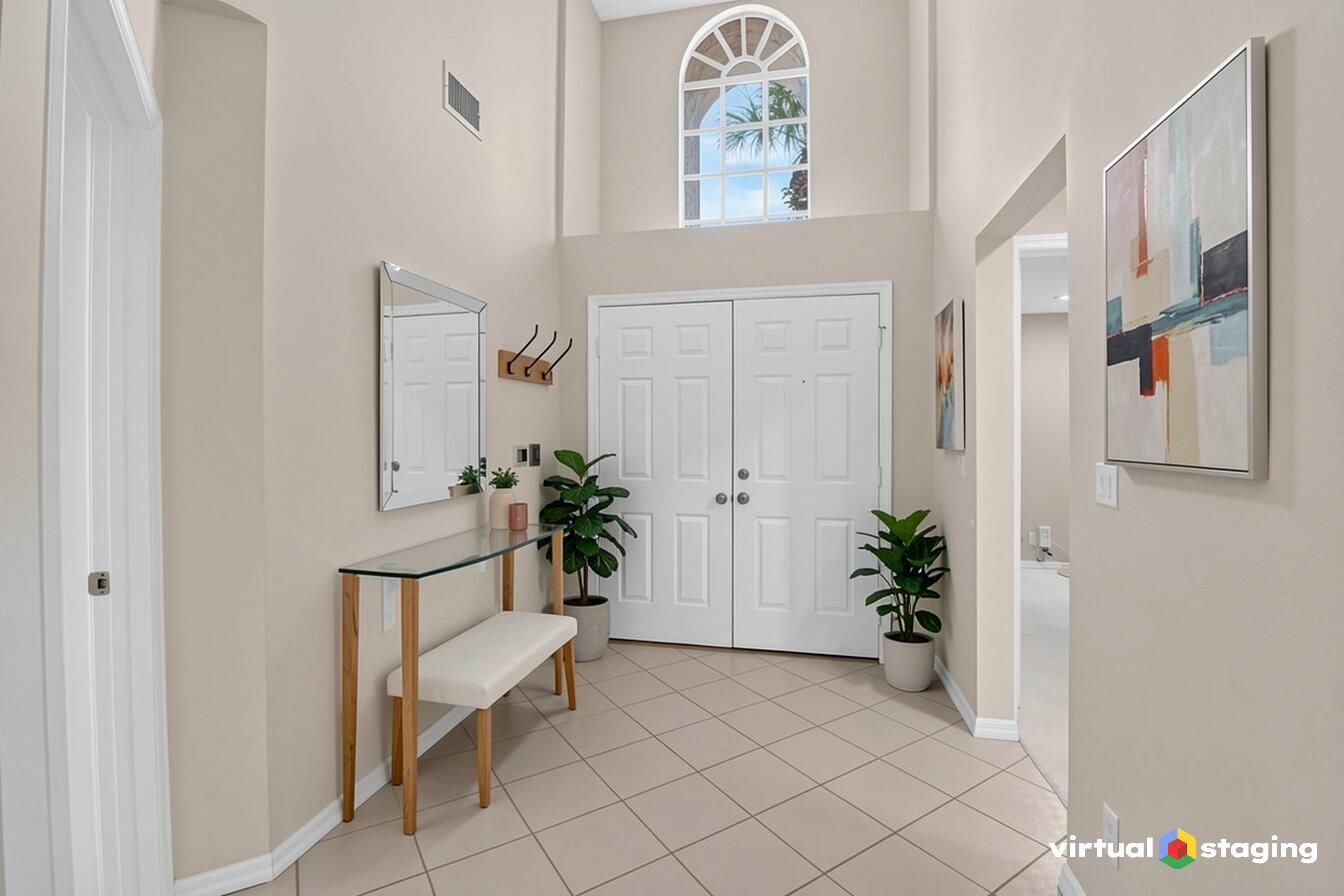 A bright entryway features a glass console table, a bench, and a tall arched window — 10911 Ladera Lane # A, Boca Raton FL 33498, BOCA RATON, FL
