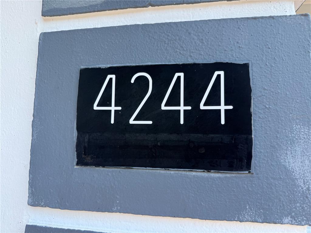 The house number 4244 is displayed in white on a black rectangular plaque — 4244 SHELDON PLACE UNIT 4244, NEW PORT RICHEY, FL