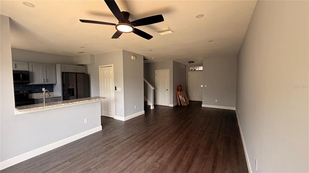 A two-story townhouse exterior features a light blue facade, a covered entryway, and an attached garage — 6236 OLIVEDALE DRIVE, RIVERVIEW, FL